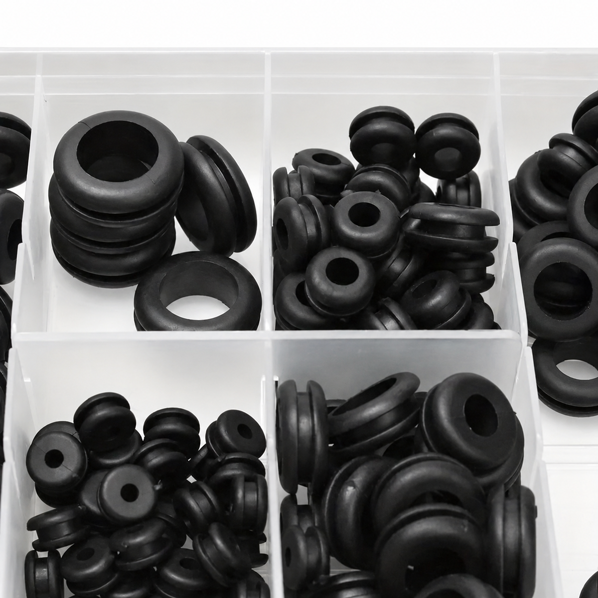 Black rubber wiring grommets arranged in a compartment case